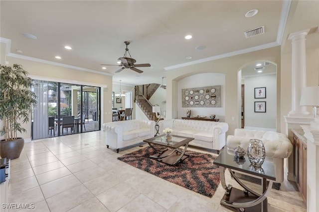 living room with ornate columns, visible vents, and crown molding