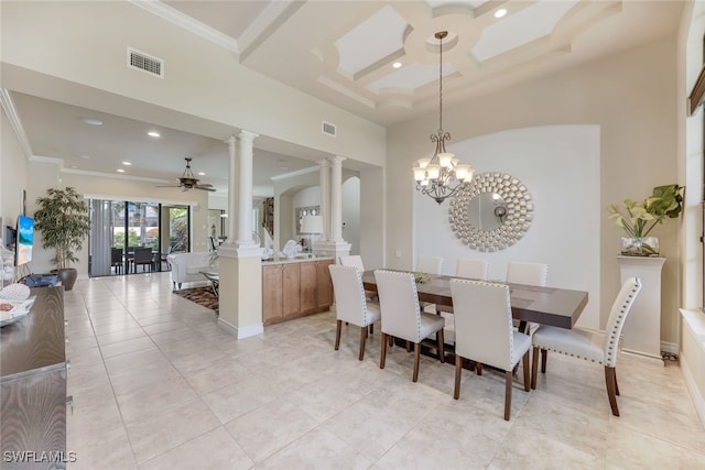 dining area featuring decorative columns, visible vents, a towering ceiling, ornamental molding, and ceiling fan with notable chandelier