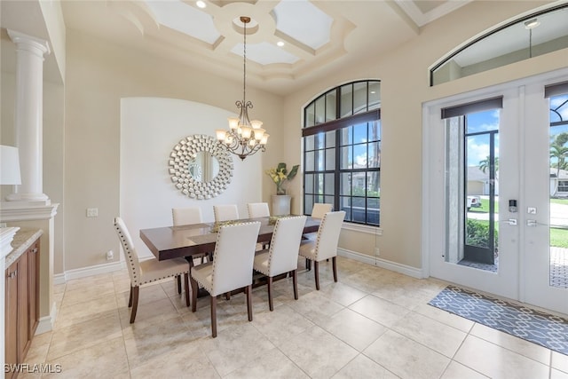 dining room featuring baseboards, french doors, coffered ceiling, and ornate columns