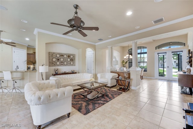 living room featuring french doors, light tile patterned floors, ornamental molding, ceiling fan, and ornate columns