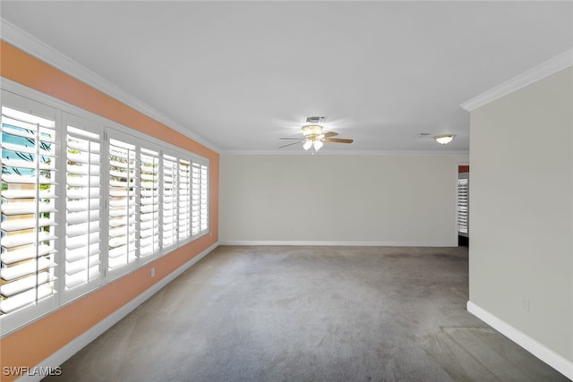 spare room with carpet floors, a ceiling fan, baseboards, and crown molding