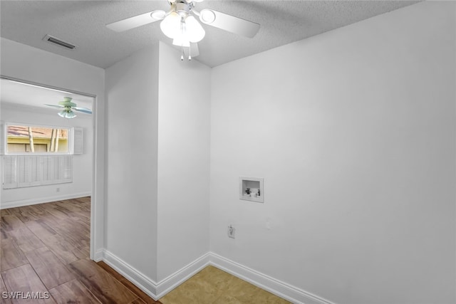 laundry room with a textured ceiling, laundry area, hookup for a washing machine, and visible vents