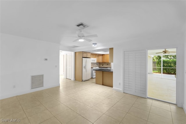 interior space with light tile patterned floors, ceiling fan, and visible vents