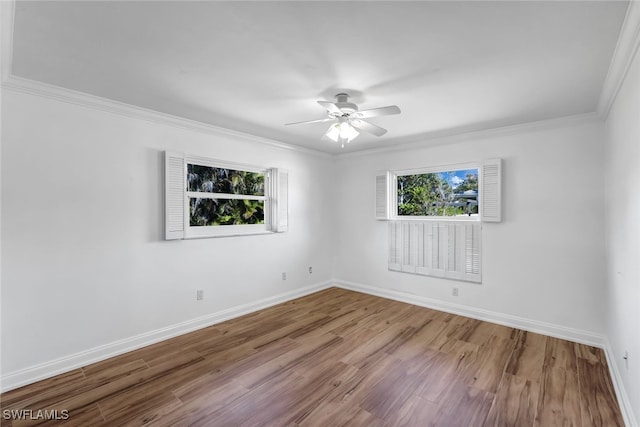 unfurnished room with ceiling fan, baseboards, wood finished floors, and ornamental molding