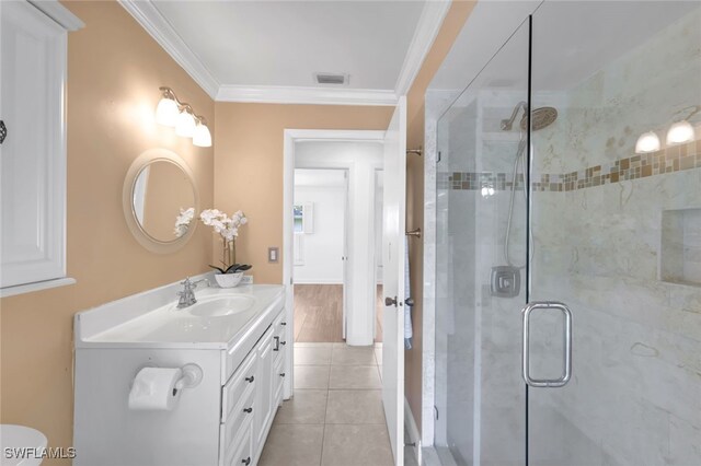 full bath with tile patterned flooring, vanity, visible vents, ornamental molding, and a shower stall