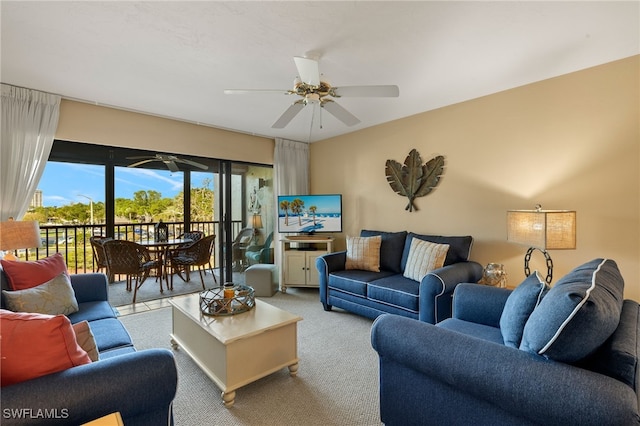 living area featuring a ceiling fan and light colored carpet