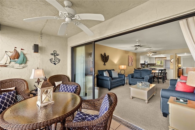 dining room featuring light carpet, a textured wall, and a textured ceiling