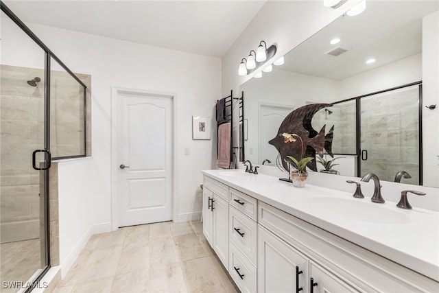 full bathroom featuring double vanity, a stall shower, a sink, and visible vents