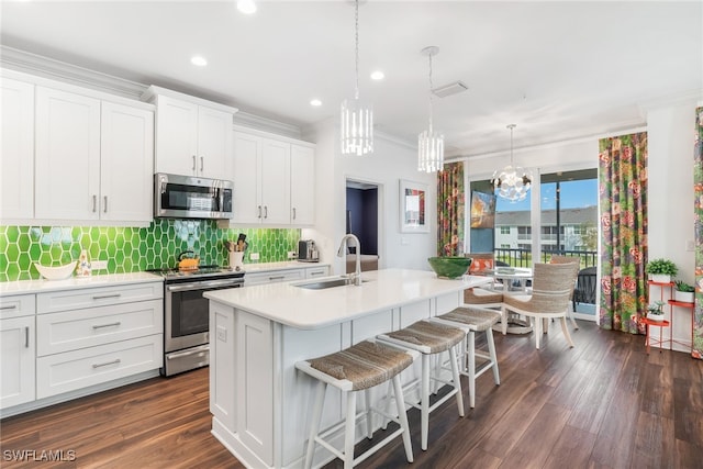 kitchen with light countertops, appliances with stainless steel finishes, and white cabinets