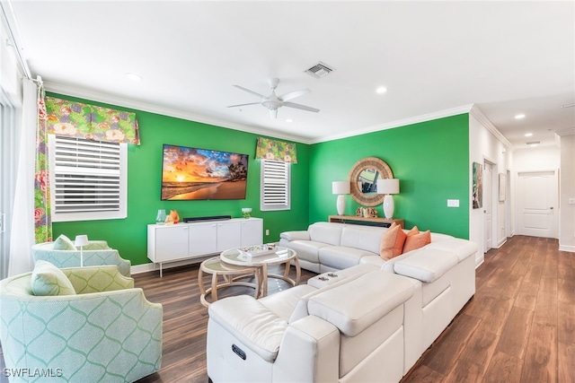 living area featuring dark wood-style floors, recessed lighting, visible vents, ornamental molding, and baseboards