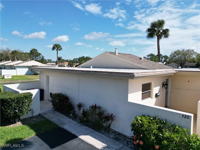 view of side of property with stucco siding