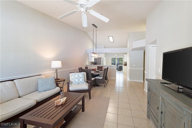 living room with light tile patterned floors, baseboards, high vaulted ceiling, and a ceiling fan