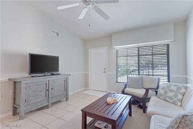 living room with lofted ceiling, visible vents, a ceiling fan, light tile patterned flooring, and baseboards