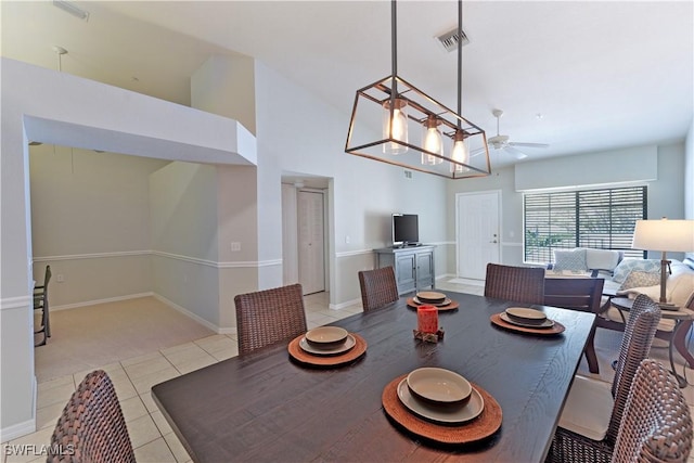 dining space featuring baseboards, light tile patterned flooring, visible vents, and a ceiling fan