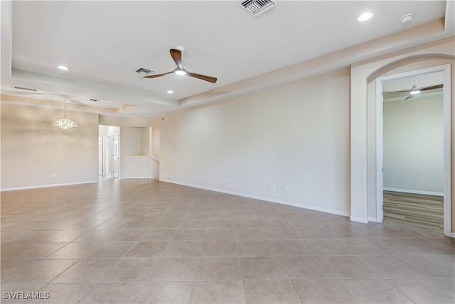 empty room featuring recessed lighting, a raised ceiling, visible vents, and ceiling fan