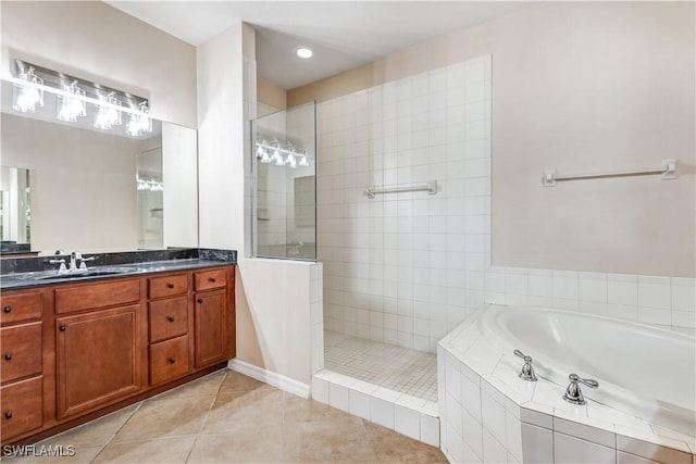 bathroom with a garden tub, vanity, walk in shower, and tile patterned floors