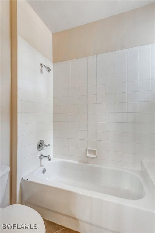 full bathroom featuring toilet, washtub / shower combination, and tile patterned floors