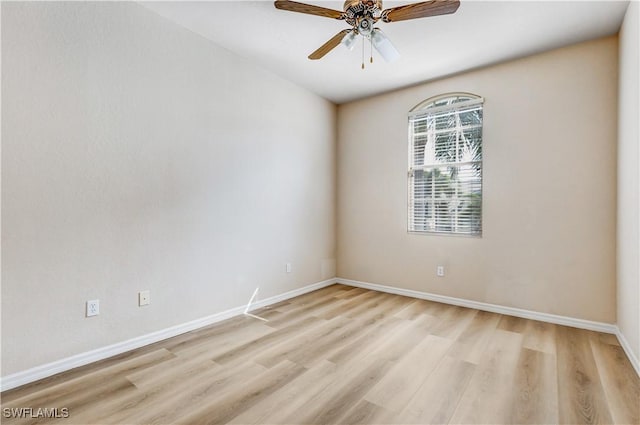 empty room featuring ceiling fan, light wood-style flooring, and baseboards