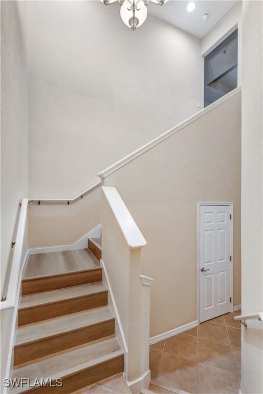 stairs with recessed lighting, baseboards, and tile patterned floors