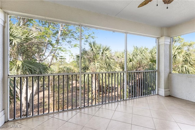 unfurnished sunroom with ceiling fan