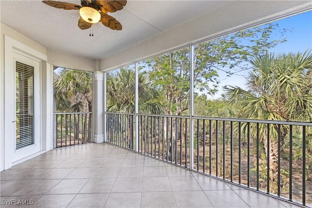 unfurnished sunroom with ceiling fan