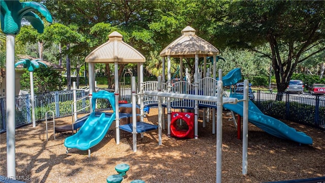 community jungle gym featuring fence