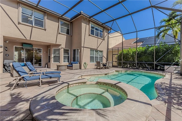 view of swimming pool featuring a patio, a lanai, and a pool with connected hot tub