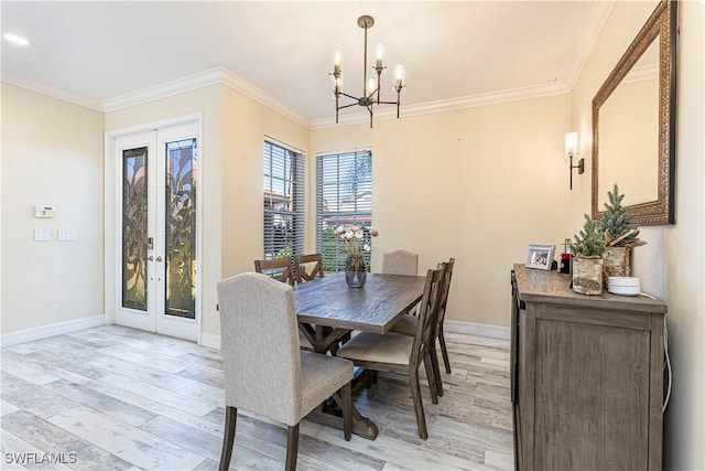 dining area with light wood finished floors, baseboards, ornamental molding, and french doors