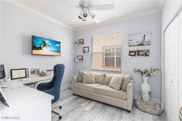 office area featuring ceiling fan, light wood-type flooring, baseboards, and crown molding