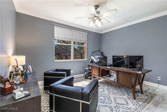 office featuring ornamental molding, ceiling fan, baseboards, and wood finished floors