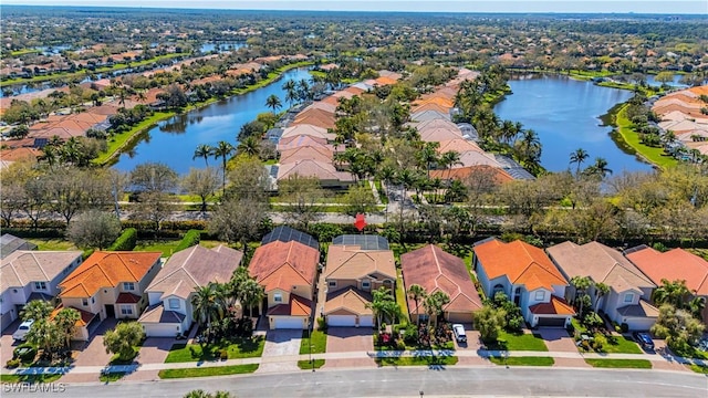 drone / aerial view with a water view and a residential view