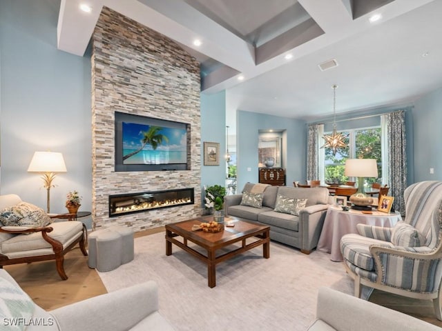 living room with visible vents, an inviting chandelier, a stone fireplace, beam ceiling, and recessed lighting