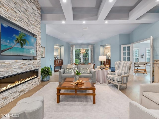 living room with light wood-style floors, recessed lighting, beam ceiling, and a fireplace