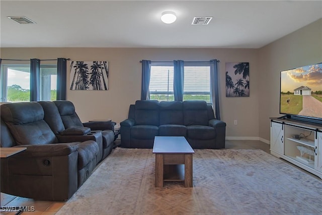 living area featuring visible vents and baseboards