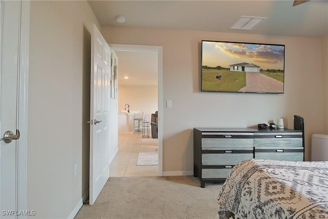 bedroom with light carpet, light tile patterned floors, visible vents, and baseboards