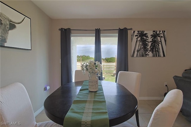 dining room with light tile patterned flooring and baseboards