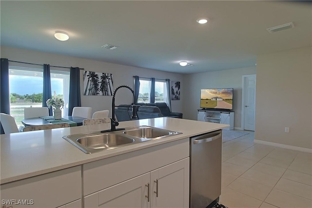 kitchen with light countertops, a sink, visible vents, and stainless steel dishwasher