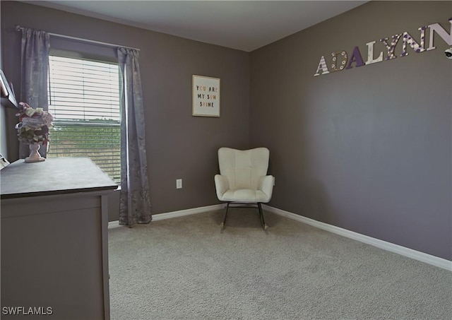 living area featuring baseboards