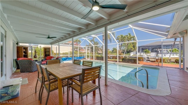 outdoor pool featuring a lanai, ceiling fan, and a patio