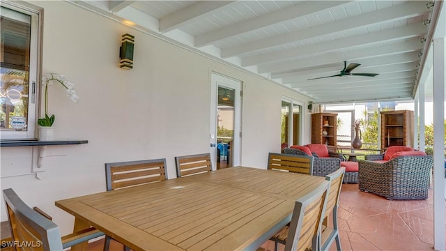 exterior space featuring a ceiling fan and beamed ceiling