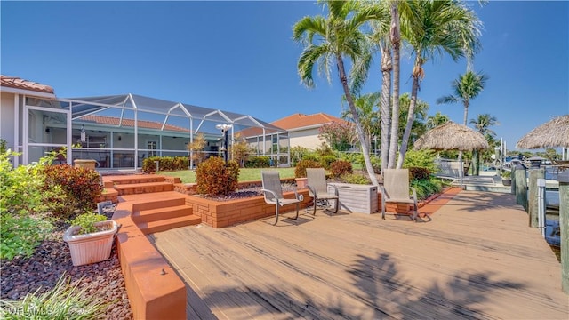 wooden deck with a lanai and a gazebo