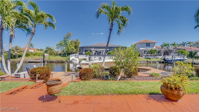 exterior space with a boat dock, a water view, boat lift, and a residential view