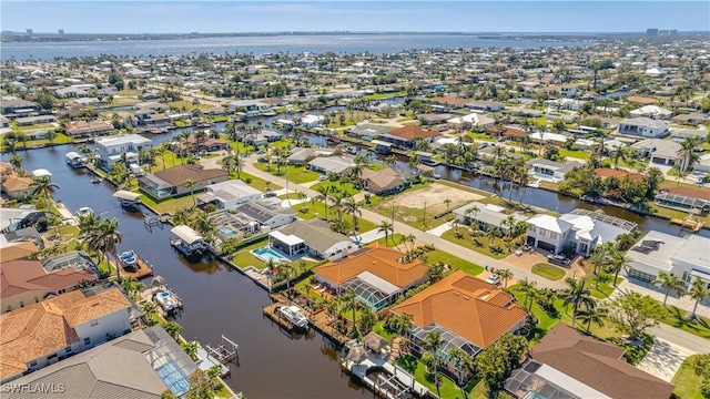 birds eye view of property with a residential view and a water view