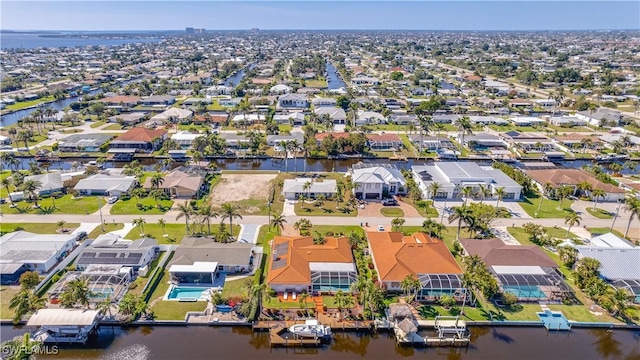 drone / aerial view featuring a residential view and a water view