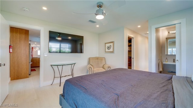 bedroom with recessed lighting, visible vents, ceiling fan, ensuite bath, and wood finished floors