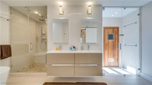 bathroom with a stall shower and vanity