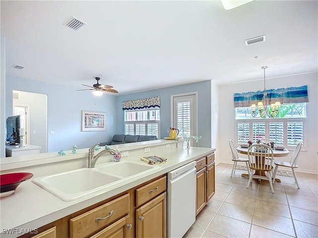 kitchen with a sink, visible vents, light countertops, and dishwasher