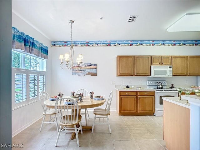 kitchen with white appliances, visible vents, light countertops, a chandelier, and pendant lighting