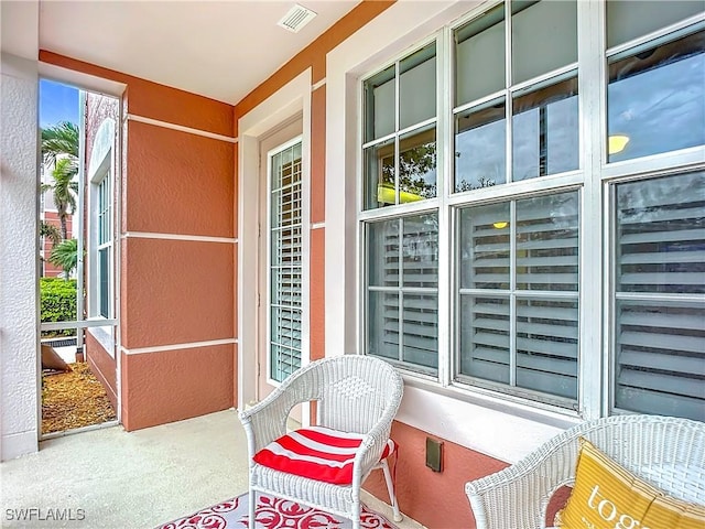 balcony featuring covered porch and visible vents