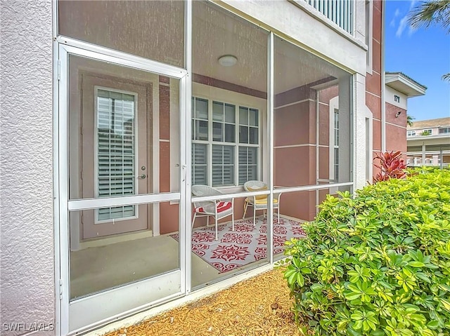 doorway to property with stucco siding